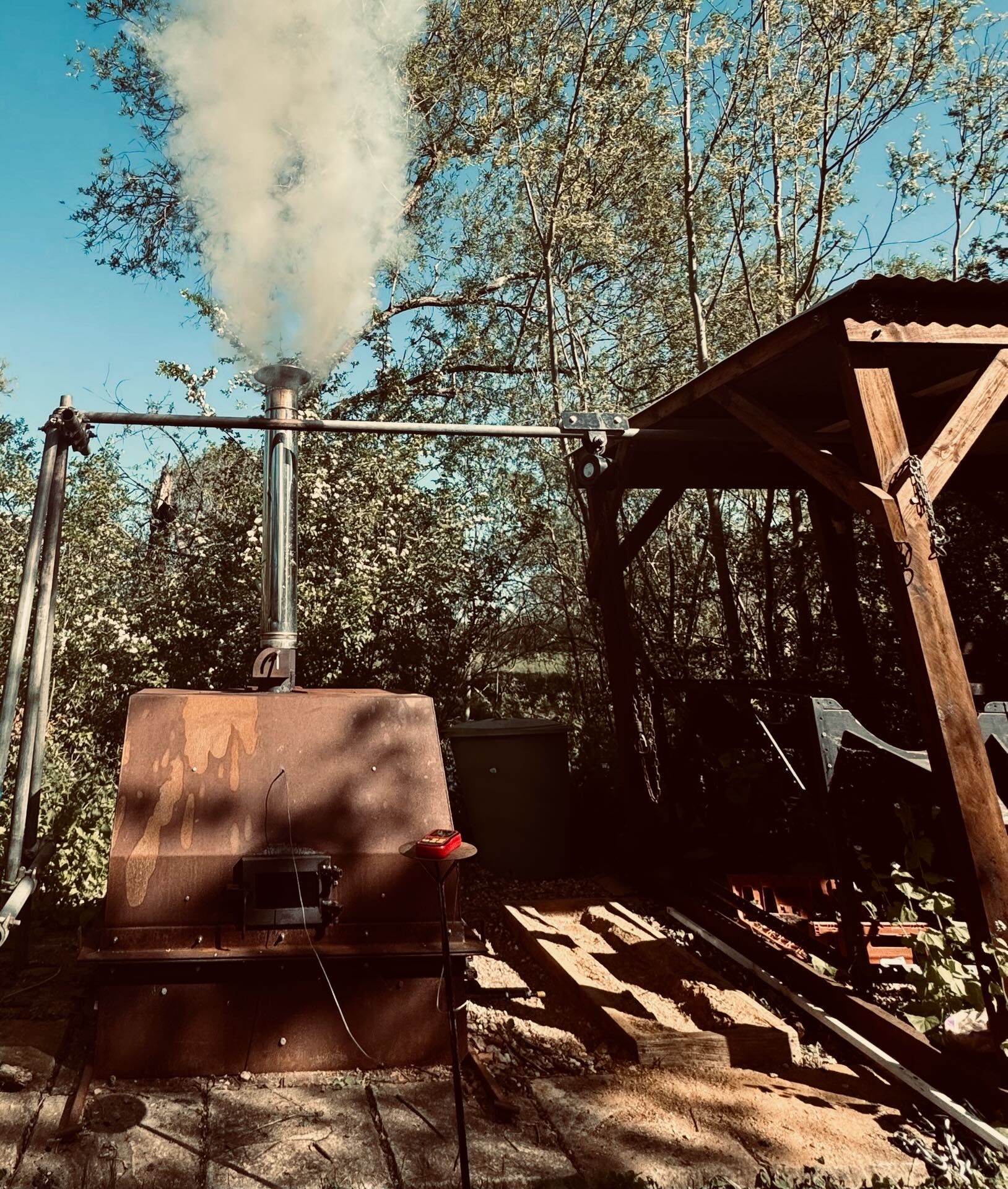 The retort kiln running, smoke rising into a winter sky